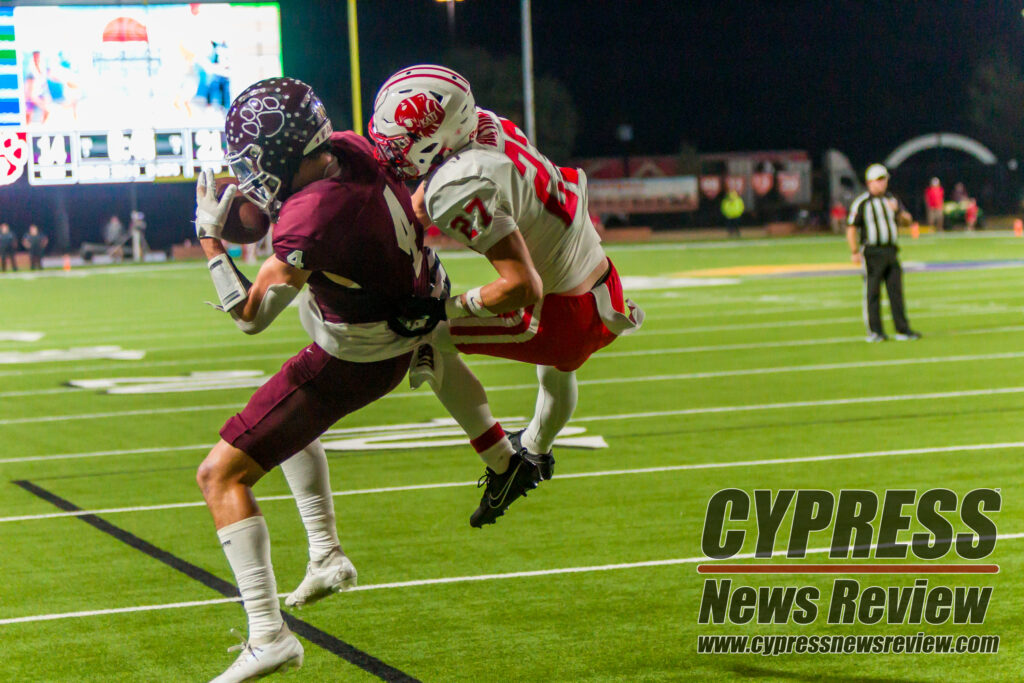 CyFair's Owen Carter (4) catches a touchdown pass to tie the Bobcats with the Tigers with 43 seconds left in the game, as Katy's Jacob Hilton (27) tries to stop the pass. The CyFair Bobcats defeated the Katy Tigers for an area championship, 28-21, in single overtime at the Berry Center, on Friday, Nov. 17, 2023. (photo by Creighton Holub, courtesy Ronin Visuals)