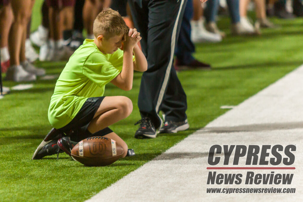 A Cyfair ball boy's prays for a Bobcat first down during overtime. The Bobcats barely made the first down. The CyFair Bobcats defeated the Katy Tigers for an area championship, 28-21, in single overtime at the Berry Center, on Friday, Nov. 17, 2023. (photo by Creighton Holub, courtesy Ronin Visuals)